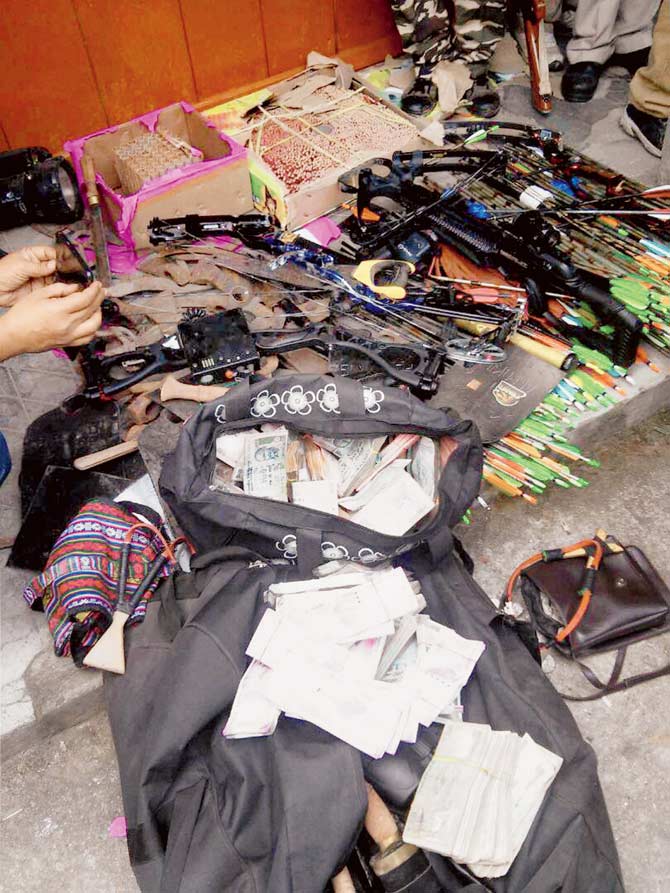 Cash, arrows, sharp weapons and explosives seized during the raids on the premises of GJMâu00c2u0080u00c2u0088chief Bimal Gurung. PIC/PTI