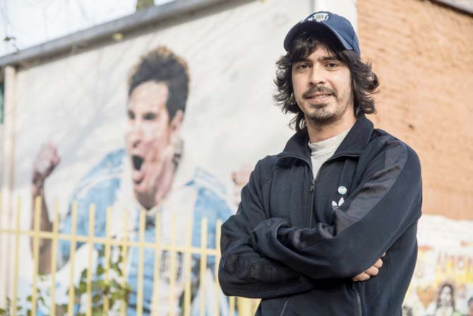 Diego Vallejos, Lionel Messi’s childhood friend, poses outside the General Las Heras primary school which they attended. Pic/ AFP