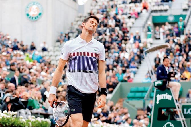 Novak Djokovic is dejected after losing a point vs Dominic Thiem during the French Open quarter-finals yesterday. Pic/AFP