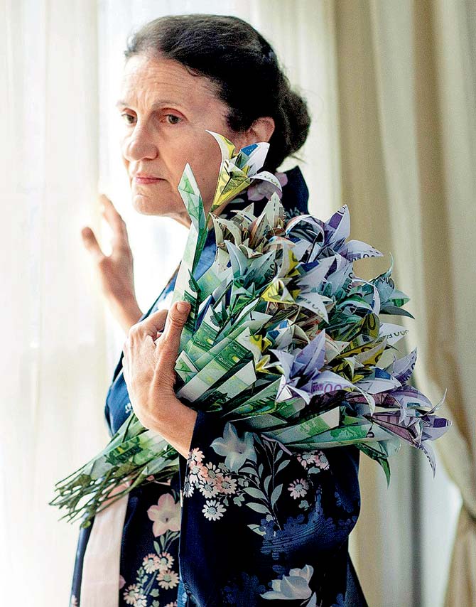 A video still featuring an art collector with flowers made using Euro banknotes