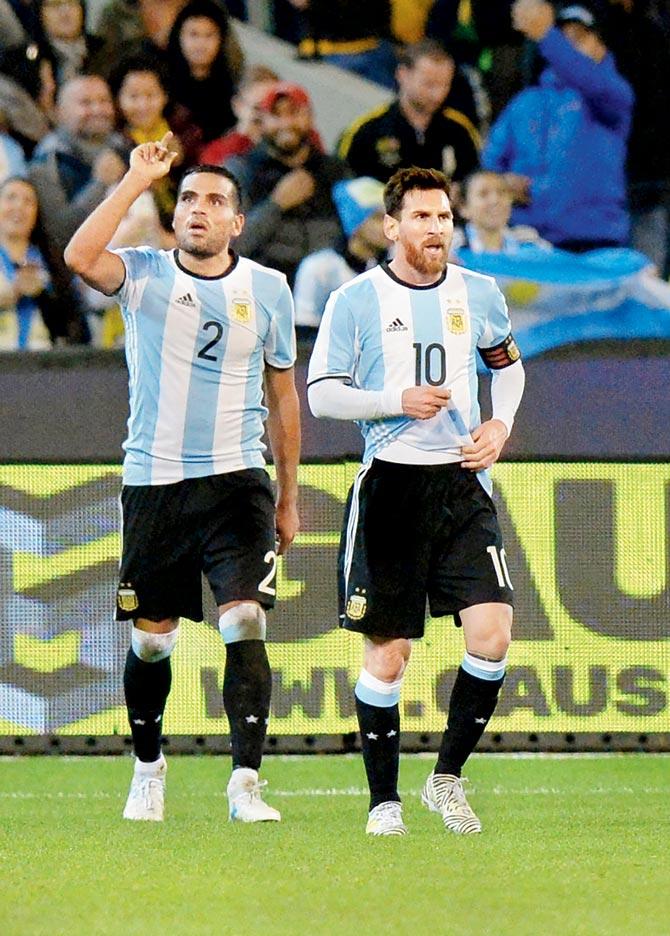 Argentina’s Gabriel Mercado (left) celebrates a goal with Lionel Messi during a friendly vs Brazil at Melbourne yesterday. Pic/AFP