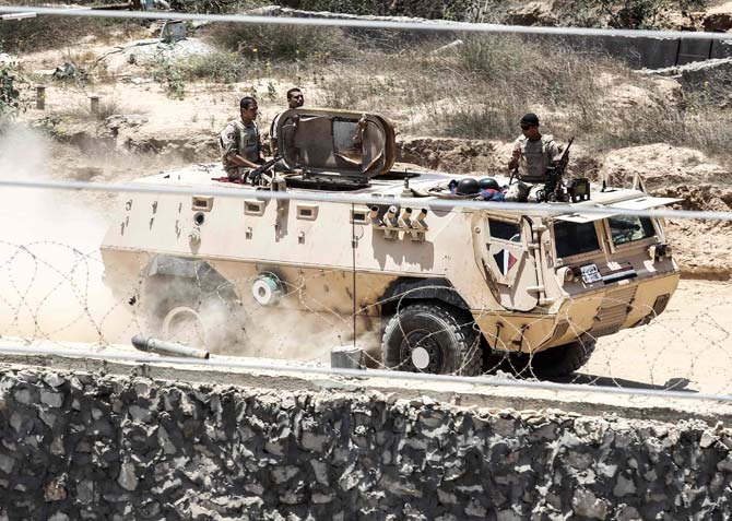 The Gaza strip border-town of Rafah shows Egyptian border guards patrolling on the other side of the border while riding in an armoured personnel carrier. Pic/AFP