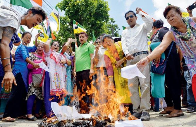 Supporters of  GJM burn copies of the GTA agreement. Pic/AFP