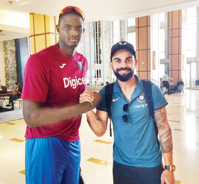 West Indies captain Jason Holder and India skipper Virat Kohli in Port of Spain, Trinidad yesterday. Pic/cricket west Indies twitter handle