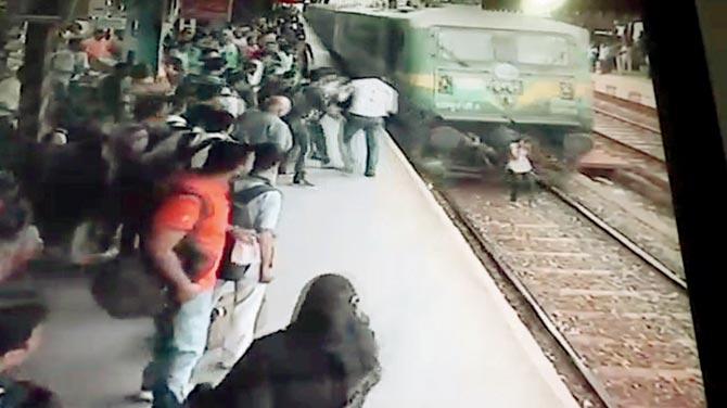 The train hits her and knocks her over