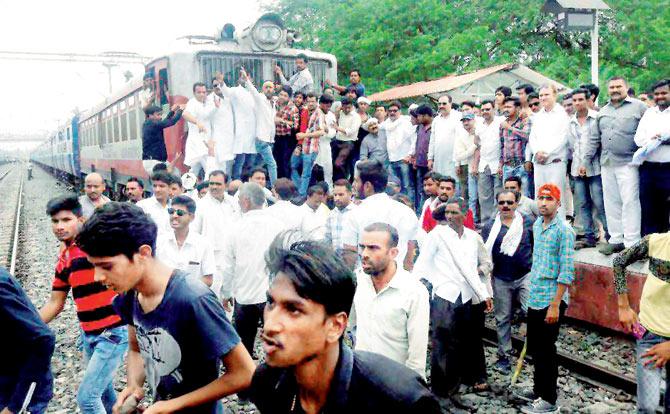 Farmers stopped a train during their nation-wide agitation in Dewas.