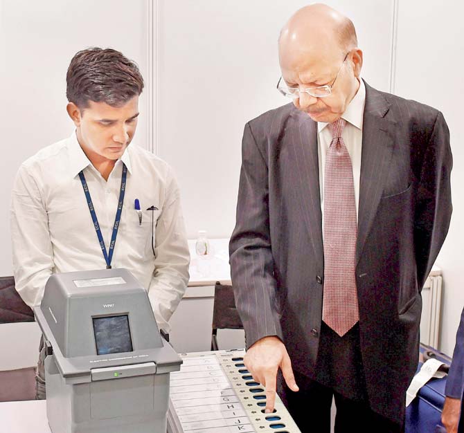 A file picture of Chief Election Commissioner Nasim Zaidi with Election Commissioner A K Joti demonstrating the working of Electronic Voting Machines (EVMs)