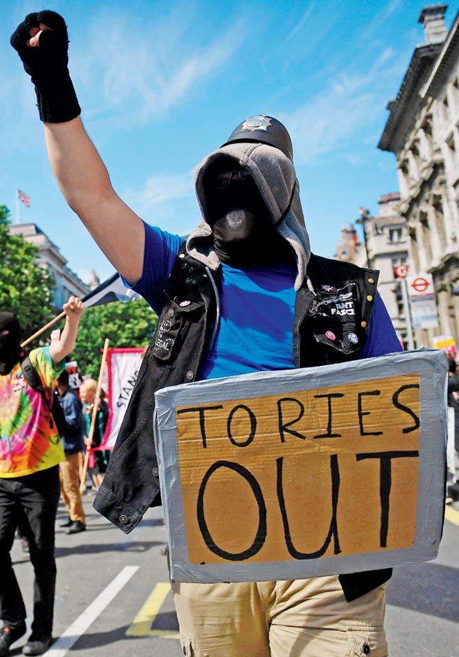 Protesters with anti-Conservative Party and anti-Democratic Unionist Party placards, and some pro-Labour ones as well,  in central London. Pics/AFP