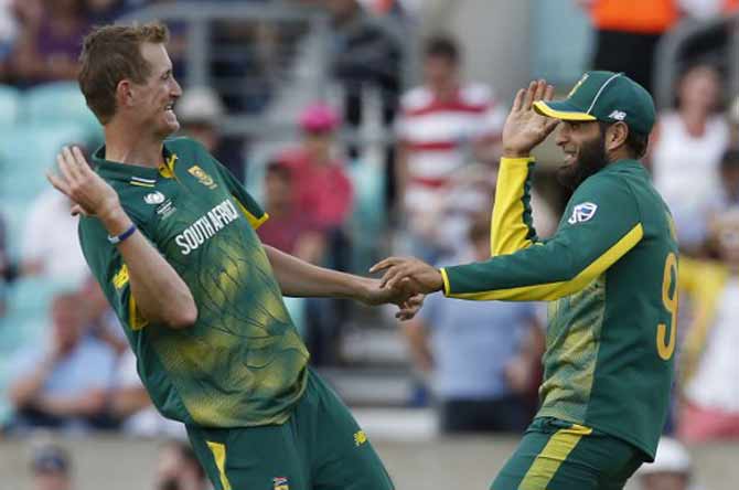 South Africa’s Imran Tahir (R) celebrates, with South Africa’s Chris Morris, running out Sri Lanka’s Suranga Lakmal for a duck during the ICC Champions Trophy match between South Africa and Sri Lanka at The Oval in London on June 3, 2017.