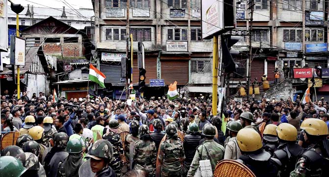 Security forces men guard as GJM supporters stage a protest rally in Darjeeling. Pic/AFP