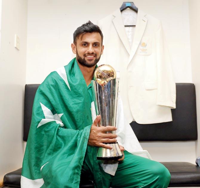 Pakistan’s Shoaib Malik poses with the ICC Champions Trophy in London recently