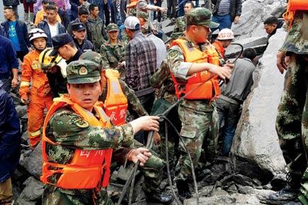 15 dead, 120 feared buried in China landslide
