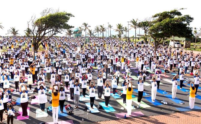 A general view shows hundreds of people taking part in a yoga session at the amphitheatre lawns at North Beach in Durban, South Africa, ahead of the International Day of Yoga. Pic/AFP