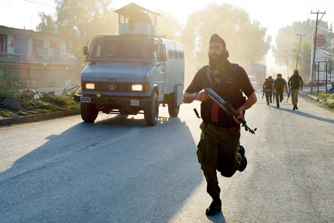 Security personnel rush towards the scene of the militant attack at Pantha Chowk on Saturday. Pic/PTI 