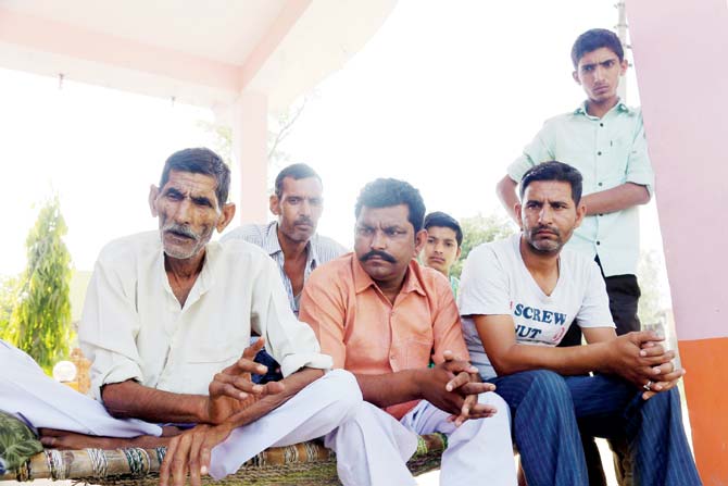 Suraj Singh (74, left), says the villagers decided to ban speakers because they wanted their children to live freely
