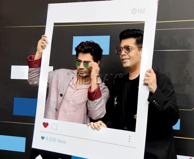 Sharing the stage with his mentor at the announcement of an awards gala, Varun Dhawan seems to have rubbed off his infectious mischievous energy on Karan Johar. Pics/Suresh Karkera, yogen shah