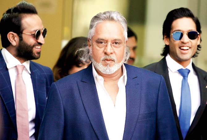 Vijay Mallya (C) leaves court in central London yesterday. Pic/AFP