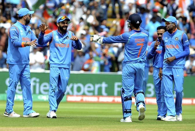India captain Virat Kohli, second left, is congratulated by teammates after dismissing Bangladesh captain Mushfiqur Rahim during the ICC Champions Trophy semifinal match between Bangladesh and India at Edgbaston. Pic/AFP