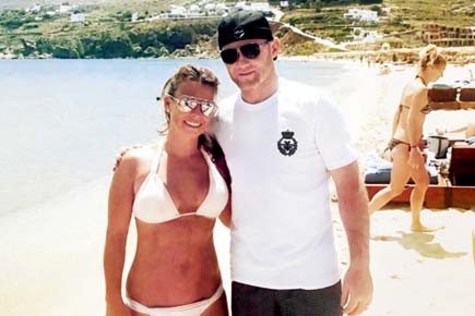 Wayne Rooney climbs on top of hot wife Coleen during sun bathing session