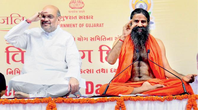 BJP president Amit Shah and Baba Ramdev at a yoga session in Ahmedabad. Pic/PTI