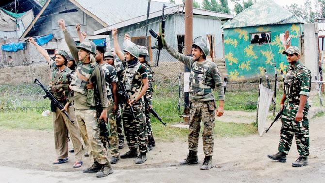 Security personnel celebrate after killing the four attackers. Pic/PTI
