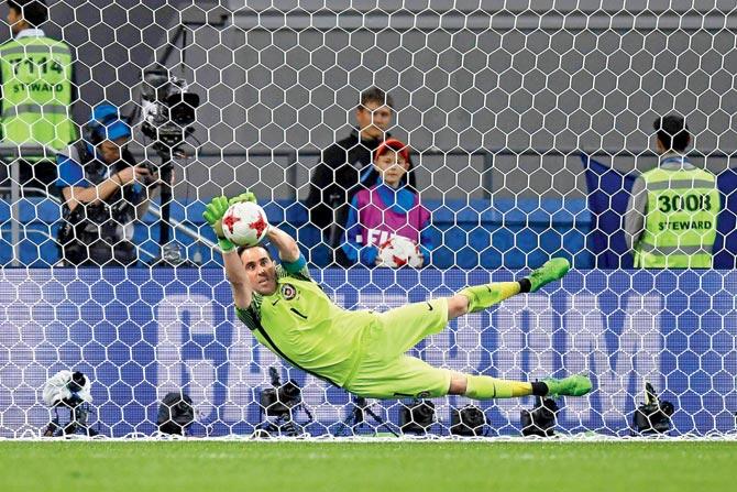 Chile’s Claudio Bravo dives to stops one of Portugal’s penalties during their Confederations Cup semi-final on Wednesday. Pic/AFP