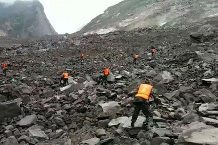 Over 100 buried in China landslide