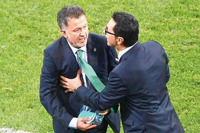 Mexico coach Juan Carlos Osorio (left) is restrained following a brawl on Wednesday. Pic/AFP
