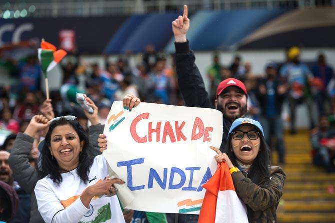 Indian cricket fans cheer and wave national flags during the ICC Champions trophy match between India and Pakistan at Edgbaston in Birmingham. Pic/AFP