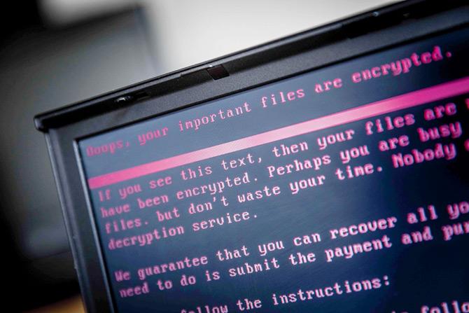 A laptop displays a message after being infected by a ransomware as part of the cyberattack. PIC/AFP