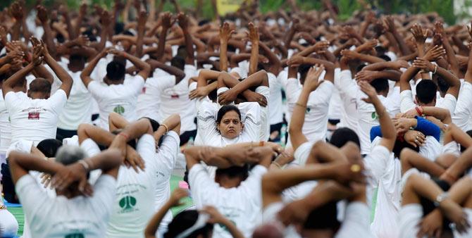 Yoga enthusiasts perform yoga at Connaught Place area to mark the 3rd International Yoga Day 2017  in New Delhi on Wednesday. PTI Photo