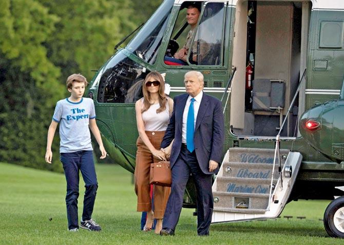 President Donald Trump, first lady Melania Trump, and their son Barron Trump walk from Marine One across the South Lawn to the White House. Pic/AFP