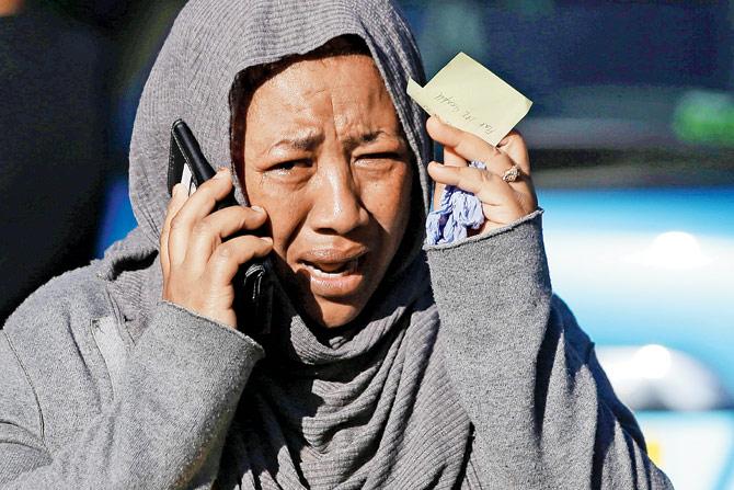 A woman cries as she tries to locate a missing relative