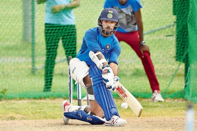 India’s Shikhar Dhawan sweeps during a practice session at Antigua yesterday. Pic/AFP