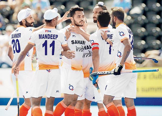 Indian players celebrate a goal against Scotland during the  World League Hockey Semi-Final game in London yesterday