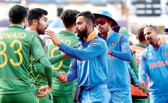 India captain Virat Kohli (right) greets Pakistan players after  the match on Sunday. Pic/AFP