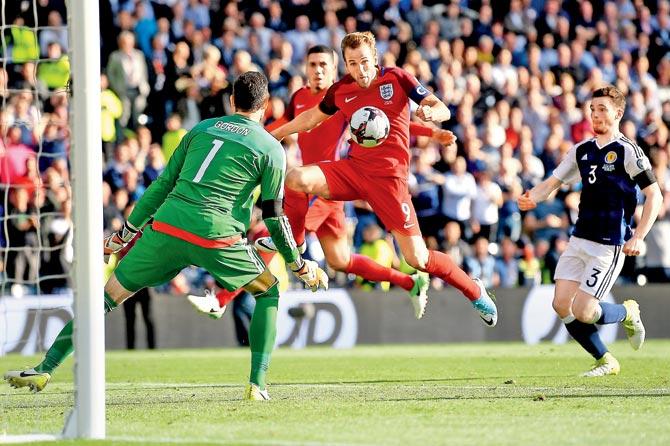 England captain Harry Kane (right) scores the equaliser against Scotland during the World Cup  qualifier at Glasgow in Scotland on Saturday. The match ended 2-2. Pic/Getty Images