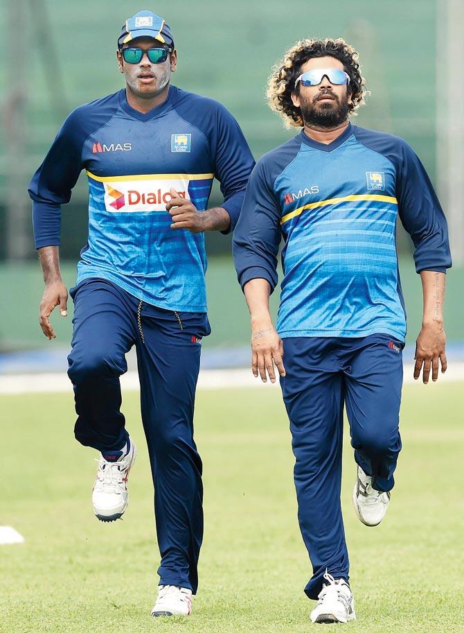 SL captain Angelo Mathews (left) and pacer Lasith Malinga during a practice session yesterday. Pic/AFP