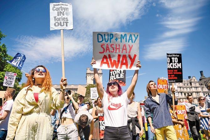 Anti-Conservative Party and anti-Democratic Unionist Party (DUP) demonstrators in central London. Theresa May is determined to form the Govt, notwithstanding the bloody nose in the general elections. Pic/AFP