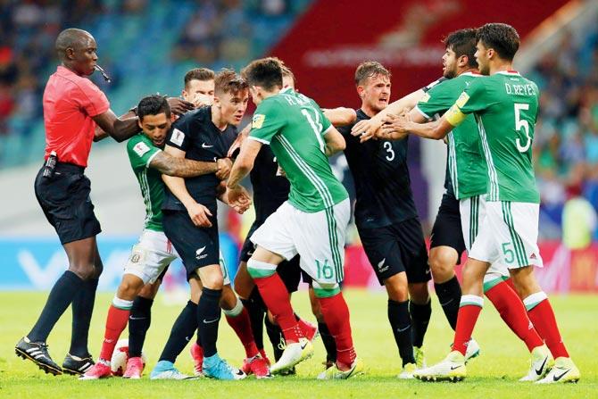 New Zealand and Mexico players trade blows during the Confed  Cup match at Sochi, Russia on Wednesday. Pic/Getty Images