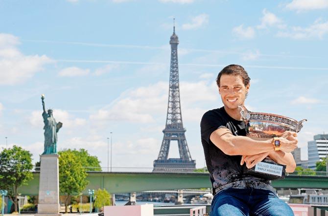 Spain’s French Open winner Rafael Nadal poses with the trophy with the iconic Eiffel Tower in the backdrop at Paris yesterday. Pic/AFP