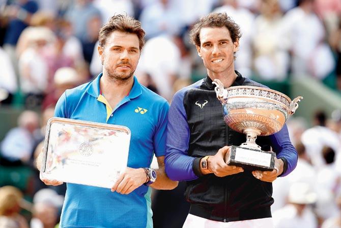Stan Wawrinka and Rafael Nadal pose with their trophies