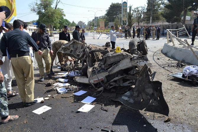 Pakistani police officers examine the site of an explosion in Quetta, Pakistan. A powerful bomb went off near the office of the provincial police chief in southwest Pakistan on Friday, causing casualties, police said. AP/PTI Photo