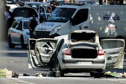 Car crashes into police van in Paris' Champs Elysees