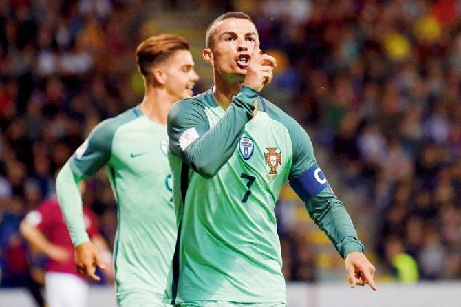 Portugal’s Cristiano Ronaldo celebrates after scoring against Latvia in Riga on Friday. Pic/AFP