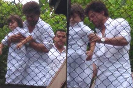 Photos: Shah Rukh Khan, son AbRam greet fans outside Mannat on Eid