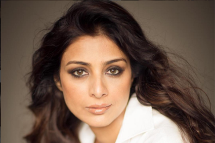 Why does Tabu blame Ajay Devgn for her single status?