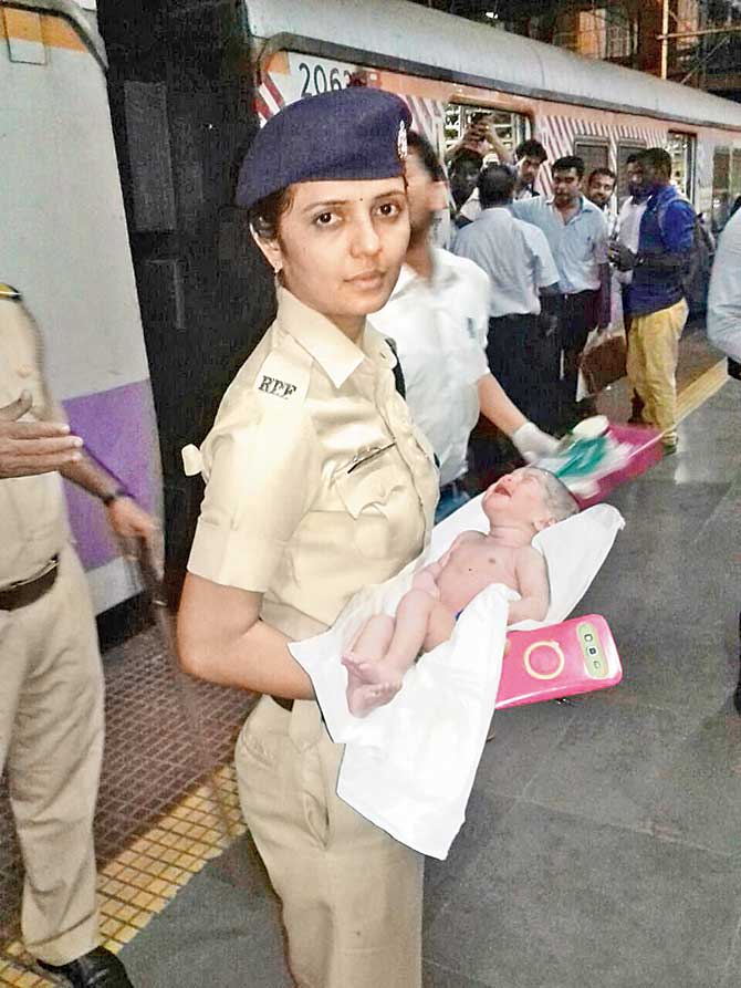An RPF officer with the baby girl who was delivered on the train at Dadar