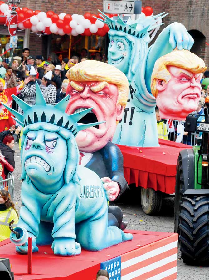 Carnival floats depicting US president Donald Trump and the Statue of Liberty take part in Duesseldorf, Germany. Pic/AFP