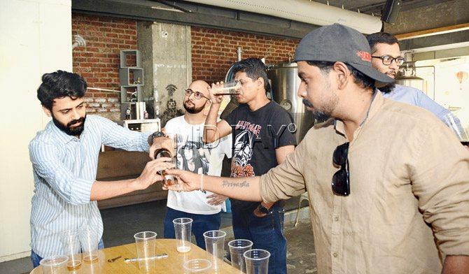 Members of Brewhanmumbai sample craft beer. Pic/Sneha Kharabe